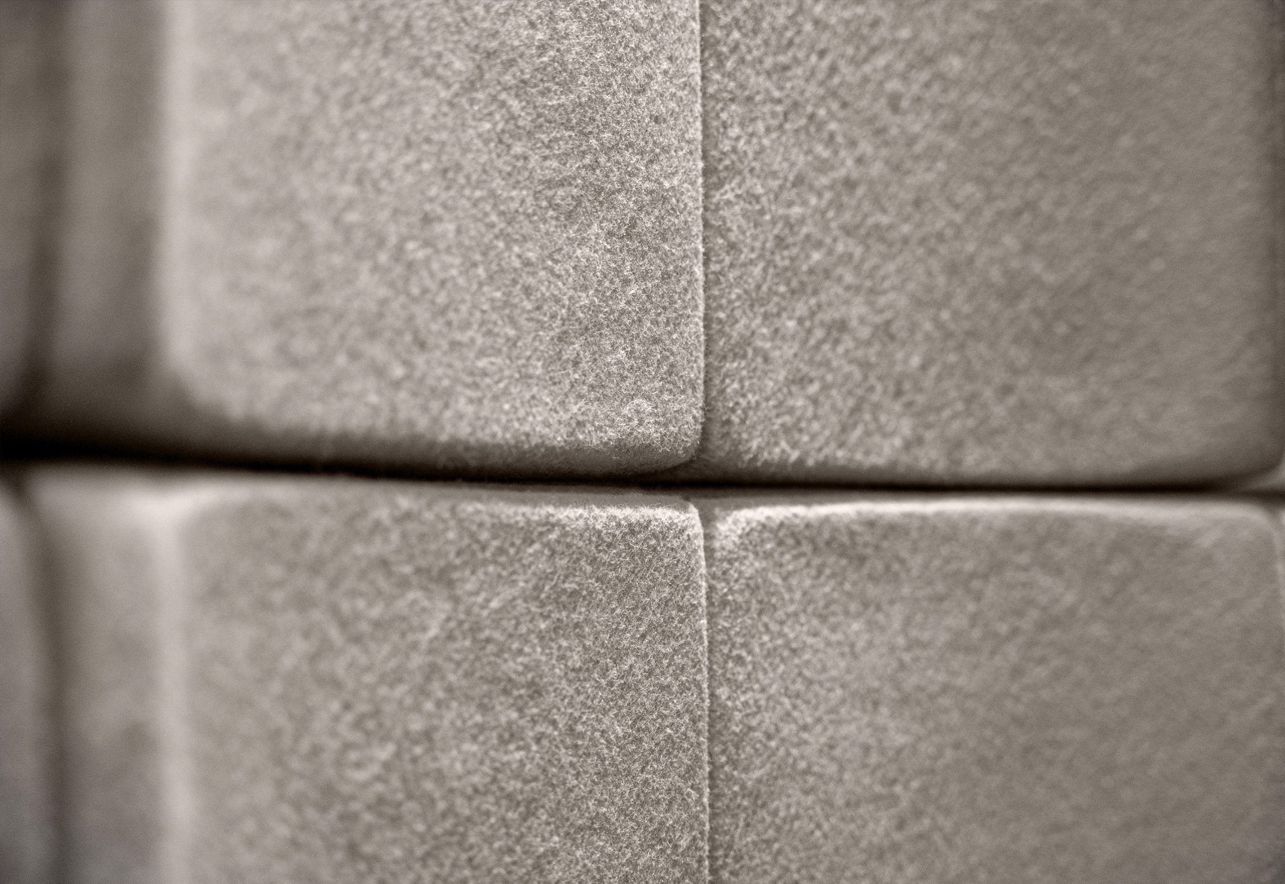 Close-up of Flux acoustic wall panels at the Akra Hotel ballroom showing the textured PET felt surface