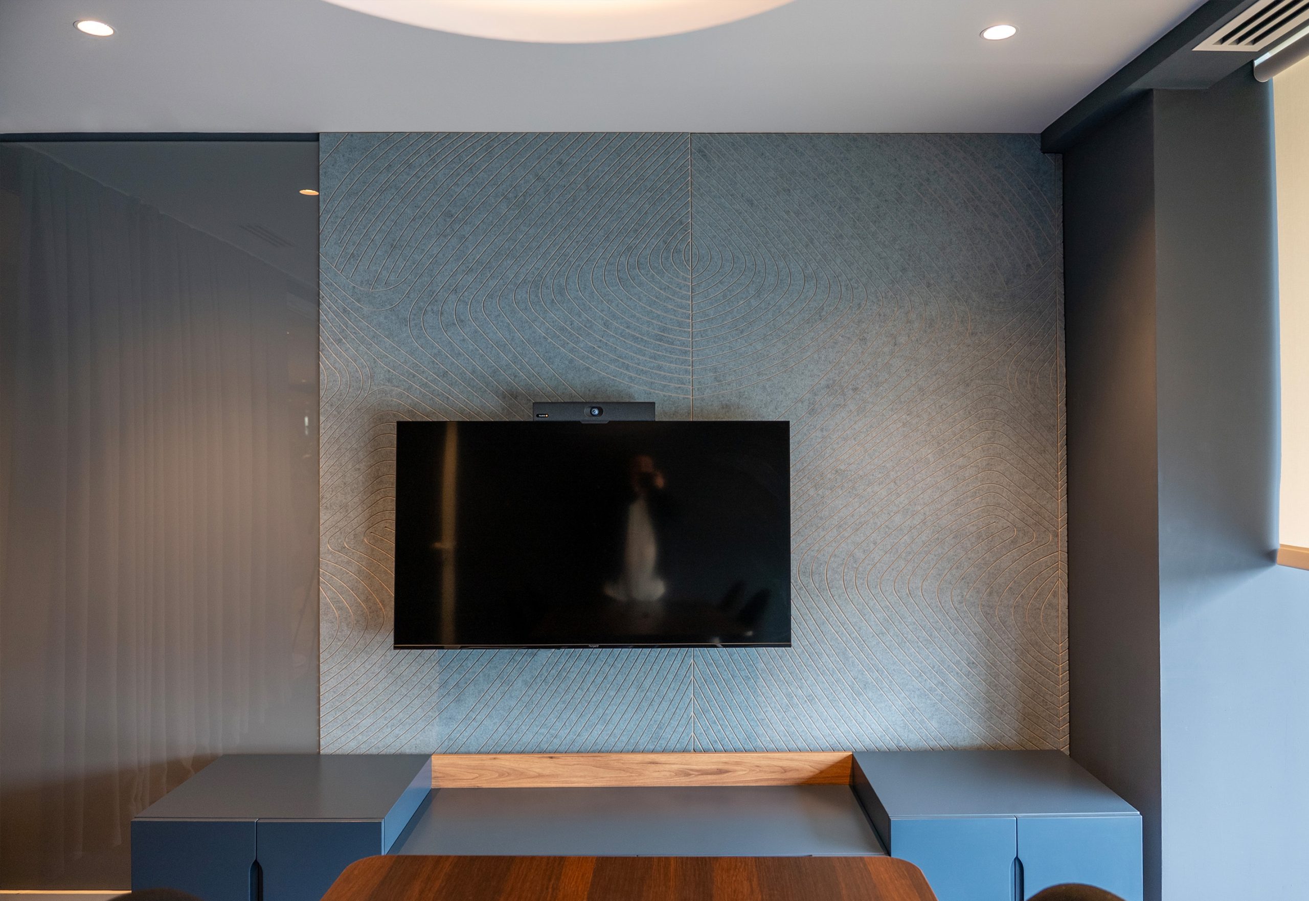 Tiles Zebra acoustic wall panel behind a TV in a modern interior